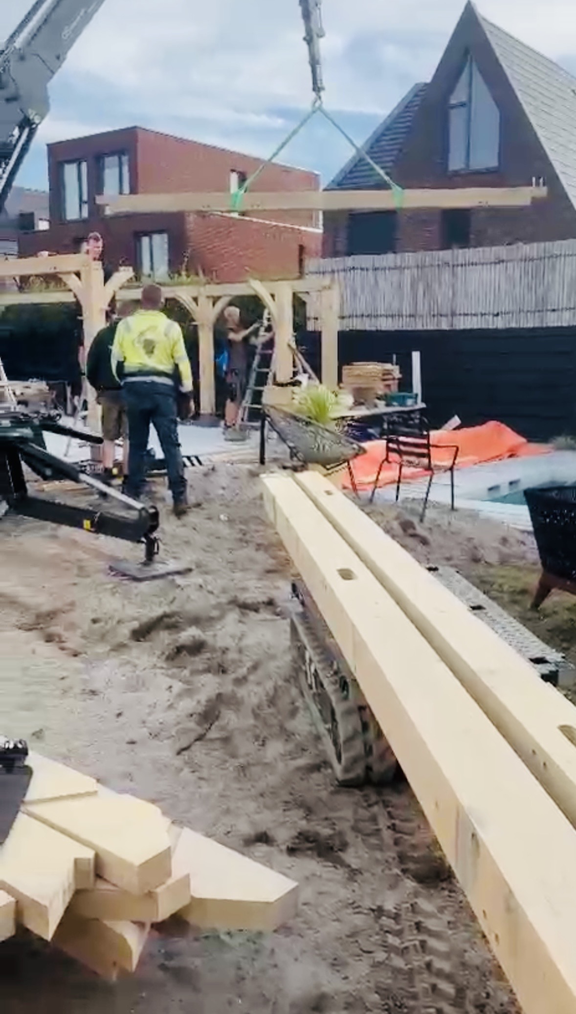 Craftsman assembling a gable roof timber frame on site