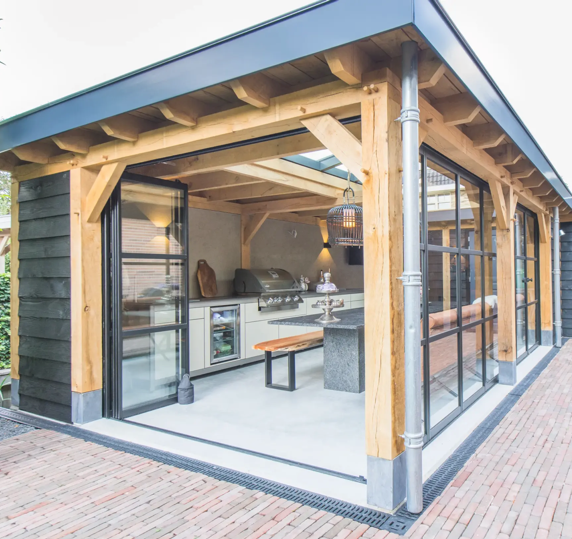 Finished oak outdoor kitchen with flat roof and glass walls
