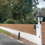 Ipé lamellen schutting gemonteerd op tuinmuur met clips