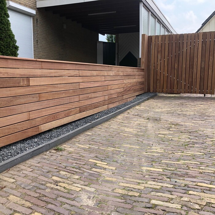 Modern architectural garden featuring bespoke Ip&eacute; slatted fencing